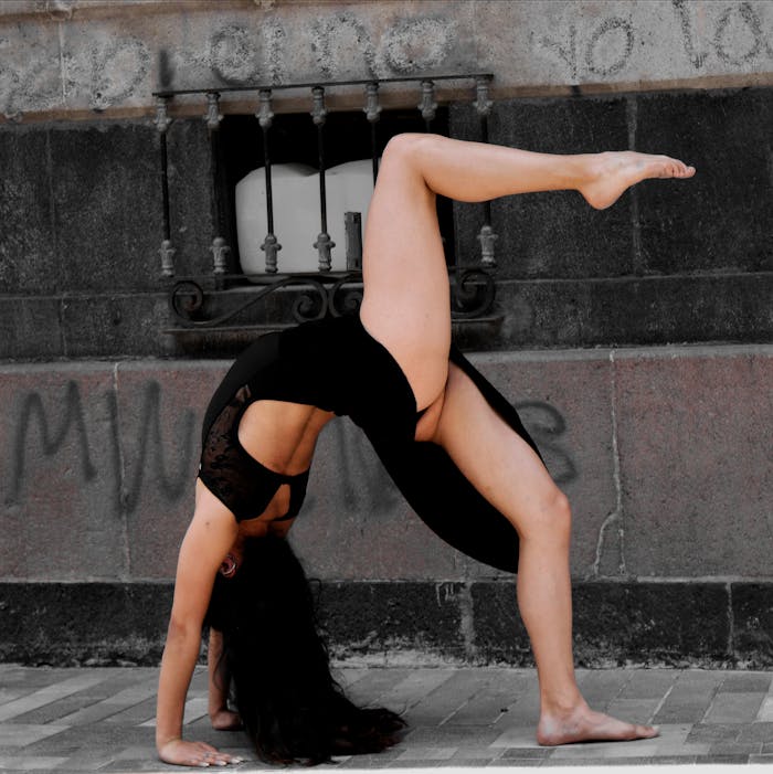 services-04 Young woman dancer showing flexibility and balance in an urban setting.